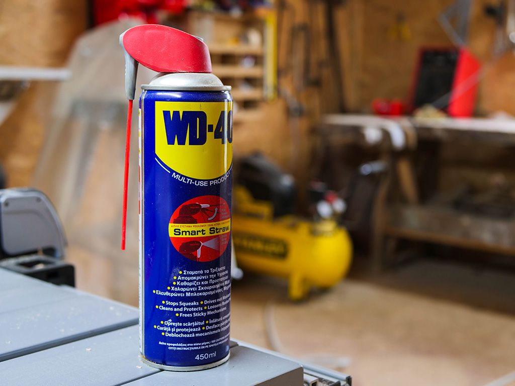 WD 40 multi use oil in a small woodworking shop, space for text.